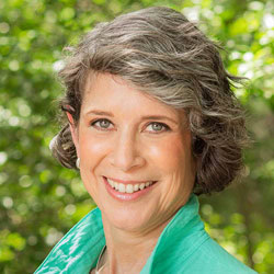 headshot of Karin Gerstenhaber with chin-length wavy hair and bright green collared shirt.